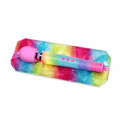 Le Wand Rainbow Ombre massager resting on matching glitter storage pouch