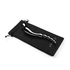 Le Wand Swerve dildo resting on a black branded satin drawstring storage pouch