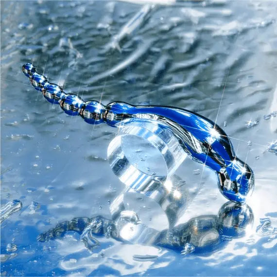 Le Wand Swerve stainless steel dildo shown submerged in water illustrating waterproof use