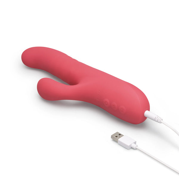 Le Wand Thrust rabbit vibrator lying flat with USB charging cable connected to base