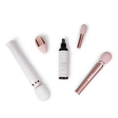Le Wand Toy Cleaner displayed alongside assorted pink and rose gold personal massagers
