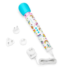 Le Wand Unicorn Wand plugged into charger with three international power adapter attachments included