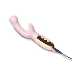 Le Wand XO vibrator connected to magnetic USB charging cable, side angle