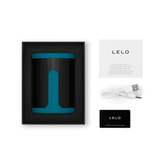 LELO F2S stroker unboxed showing device, USB charging cable, manual, and warranty card