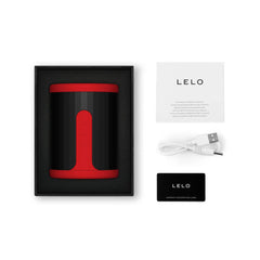 LELO F2S stroker unboxed with USB charging cable, manual, and warranty registration card