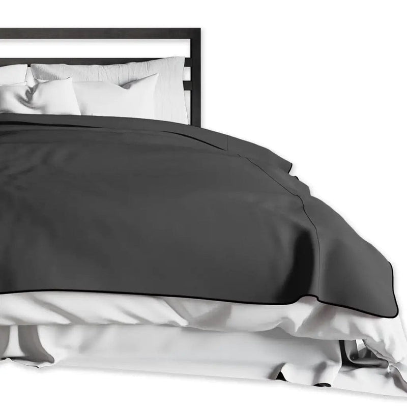 moisture resistant blanket black folded on the bed