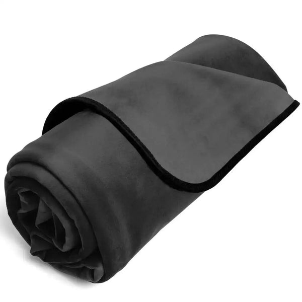 Liberator Fascinator Mini throw rolled up, showing black microvelvet exterior with bound edge