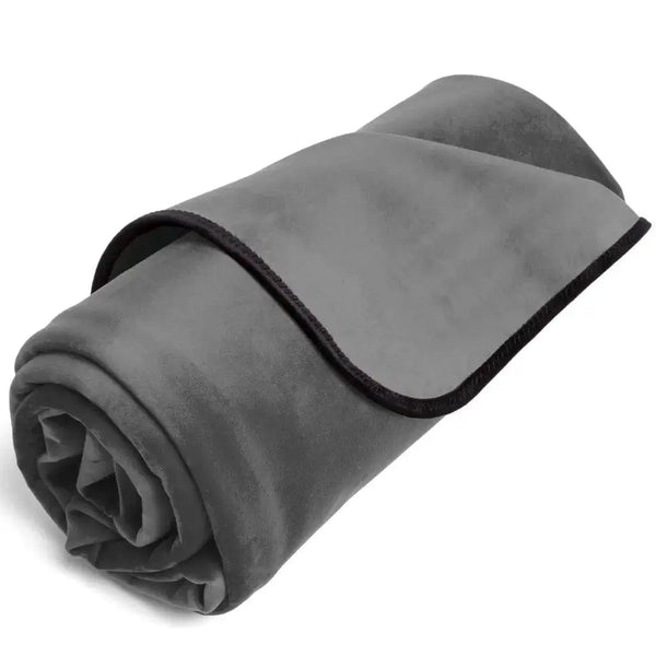 Liberator Fascinator Mini throw rolled up, showing soft grey micro-velvet top and black trim