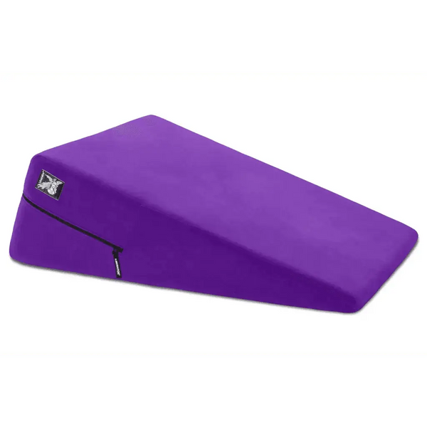 Liberator Ramp Positioning Pillow in bold purple with firm wedge shape and zippered microfiber cover