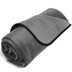 Liberator Fascinator Lush Throw King rolled up, showing grey microvelvet top and dark binding edge