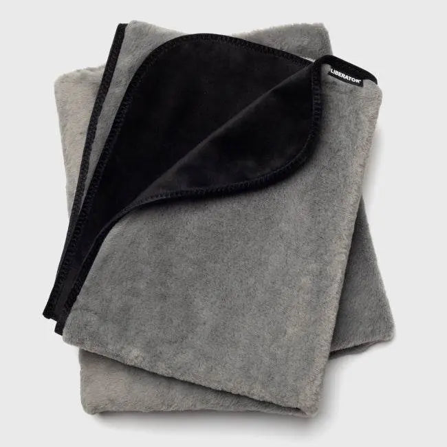 Liberator Fasinator Throw folded to reveal soft grey faux fur and sleek black velvet reverse side