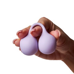 Lilac SVibe Snail TWINN finger vibrator squeezed gently to show soft, flexible silicone