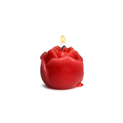 Lit red rose drip candle on white background with melted wax dripping down the paraffin base