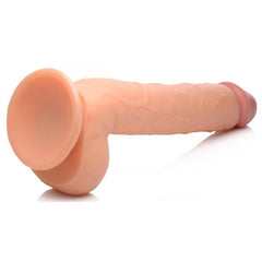 Long Logan 10-inch dildo with balls lying on its side, displaying suction cup base and curved silhouette