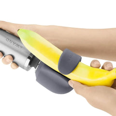 Loop silicone attachment fitted onto a banana held against a Le Wand massager, showing one use position