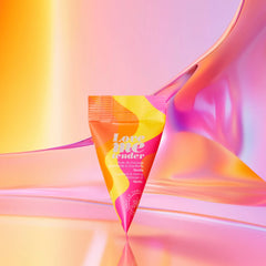 Love to Love Love Me Tender warming massage oil cone-shaped sachet on iridescent pink background