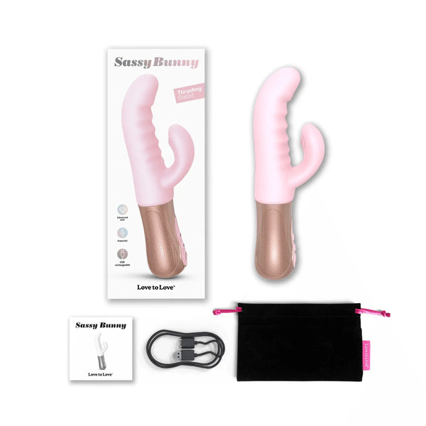 Love to Love Sassy Bunny rabbit vibrator in baby pink with rose gold base, shown with box, charging cable, and pouch