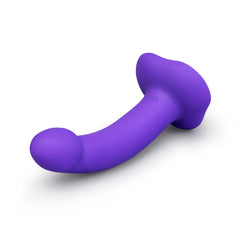 Low-angle three-quarter view of purple dildo and suction base showing smooth silicone texture