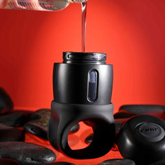 Lube being poured into the top reservoir of the black silicone Wet It Be stroker