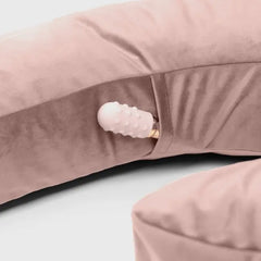 Close-up of the Lune pillow's discreet inner pocket holding the included Palm Vibrator accessory