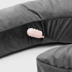 Close-up of the Lune pillow's internal zipper pocket holding a small Palm Vibrator accessory