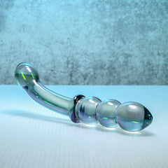 Lustrous Galaxy Wand glass dildo resting horizontally showing translucent beaded texture detail