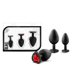 Luxe Bling Plugs Training Kit with retail packaging beside three black plugs with red gem detail