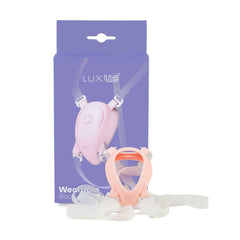 LUXUS adjustable strap-on harness removed from box, showing flexible straps and pink silicone cup