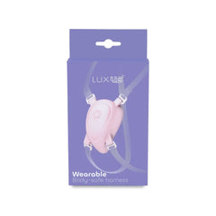 LUXUS Wearable Body-Safe Harness in soft pink silicone, front view in purple retail box