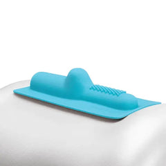 Close-up of Magic Hide aqua silicone attachment resting on a smooth white curved surface