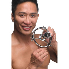 Male model holding Master Series Forced Spread speculum, showing polished steel ring size
