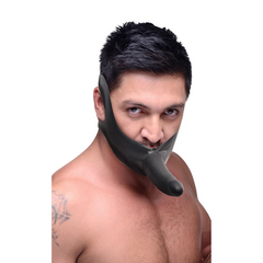 Male model wearing black face strap-on harness, illustrating fit and scale against the face