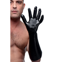 Male model wearing the full-length black textured fisting glove to show fit and forearm coverage