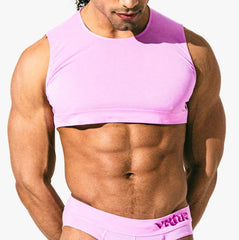 Male model wearing taffy pink Virtue Mini Crop Top, cropped silhouette on muscular frame