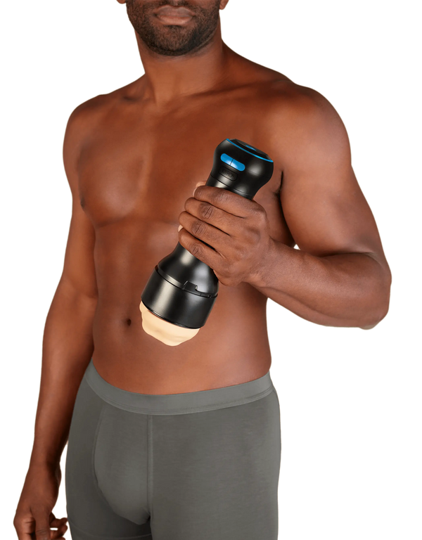 Man holding the assembled Kiiroo Control male masturbator at waist height, showing full device scale