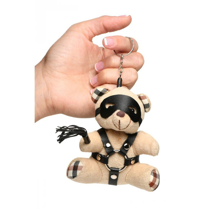 Master Series BDSM Teddy Bear Keychain held in hand, showing plaid accents and leather harness