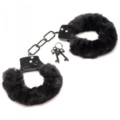 Close-up of Master Series black plush handcuffs showing metal chain link and key detail