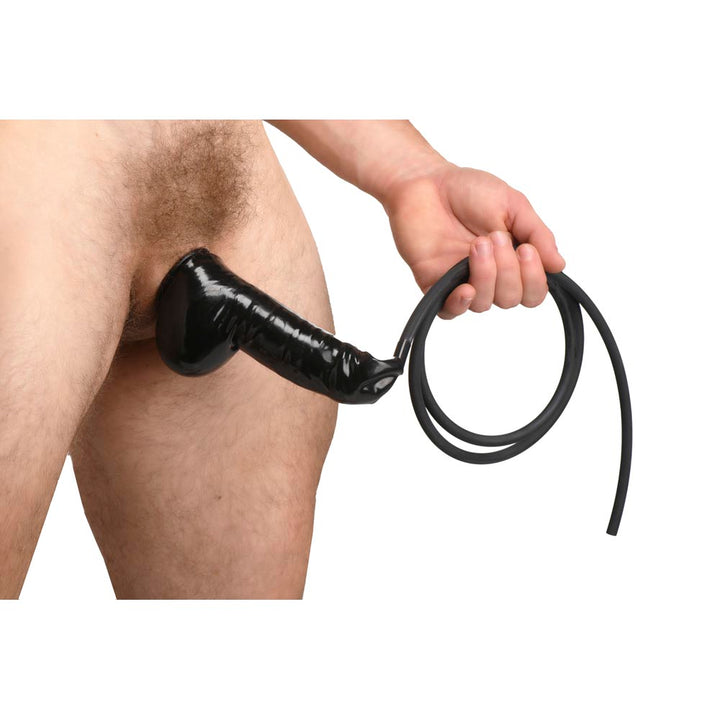 Master Series Guzzler black realistic penis sheath worn with flexible silicone tubing attached