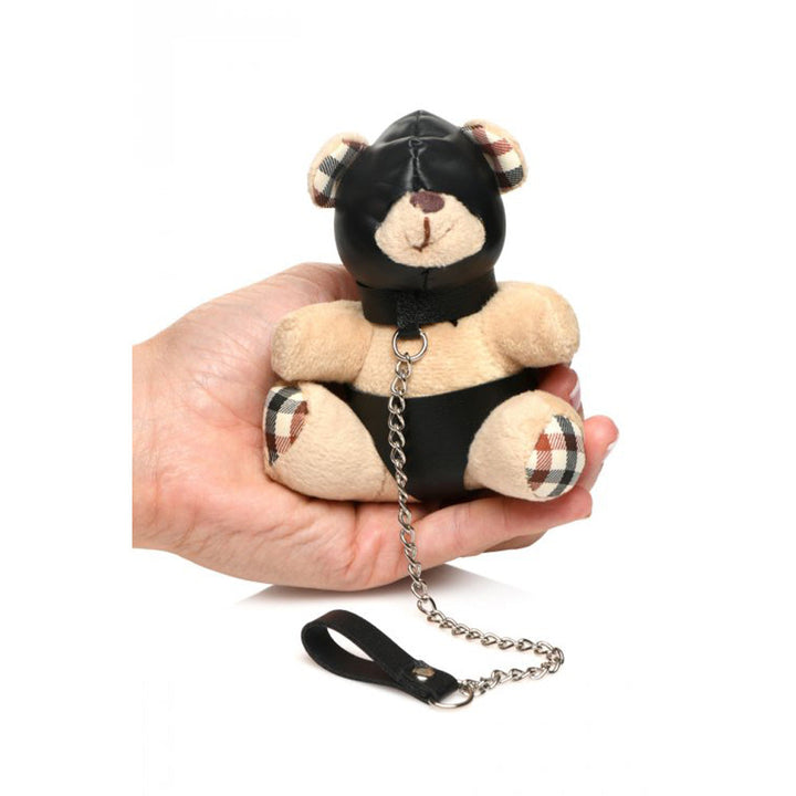 Master Series Hooded Bondage Teddy Bear Keychain held in one hand, showing plush bear with black faux-leather hood and leash