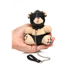 Master Series Hooded Bondage Teddy Bear Keychain held in one hand, showing plush bear with black faux-leather hood and leash