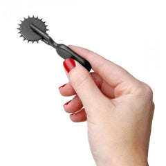 Master Series Lil Devil Mini Sensation Wheel held in hand, showing black spiked rolling wheel