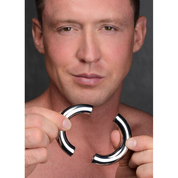 Master Series Mega Magnetize cock ring shown in two polished stainless steel halves held apart
