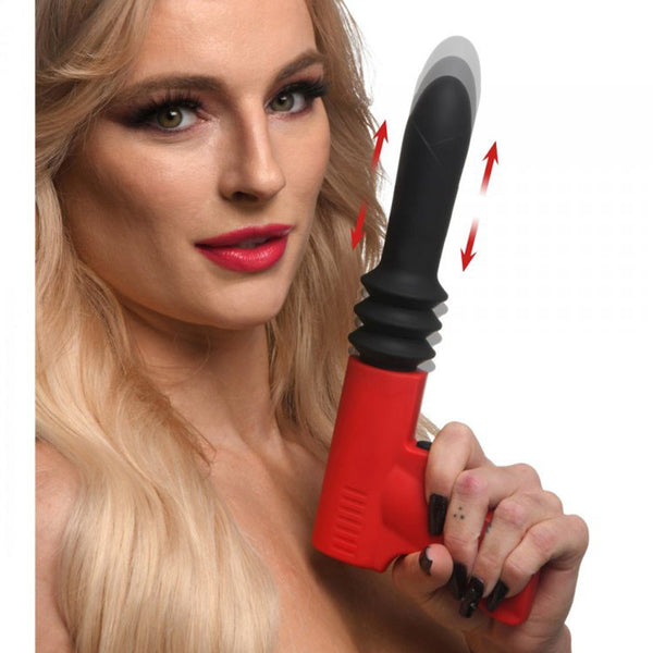 Master Series Pistol Pounder thrusting vibrator held by model, showing red handle and black silicone shaft