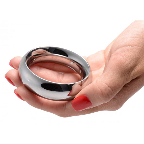Master Series Sarge 2.25 polished stainless steel cock ring held in a hand showing scale
