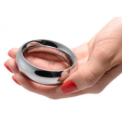 Master Series Sarge 2.25 polished stainless steel cock ring held in a hand showing scale