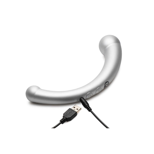 Master Series Sil stimulator lying flat with USB charging cable connected, showing control buttons
