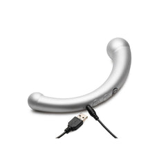 Master Series Sil stimulator lying flat with USB charging cable connected, showing control buttons