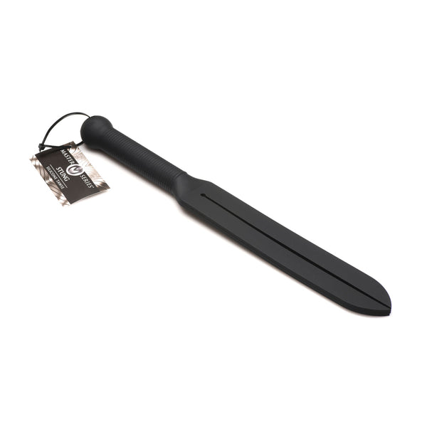 Master Series Stung Silicone Tawse lying flat, showing full black silicone paddle and ribbed handle