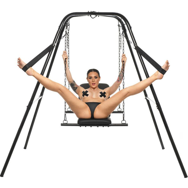 Master Series Throne sex swing with stand, model seated on padded black sling, legs in stirrups