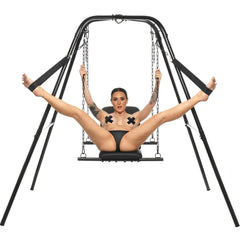 Master Series Throne sex swing with stand, model seated on padded black sling, legs in stirrups